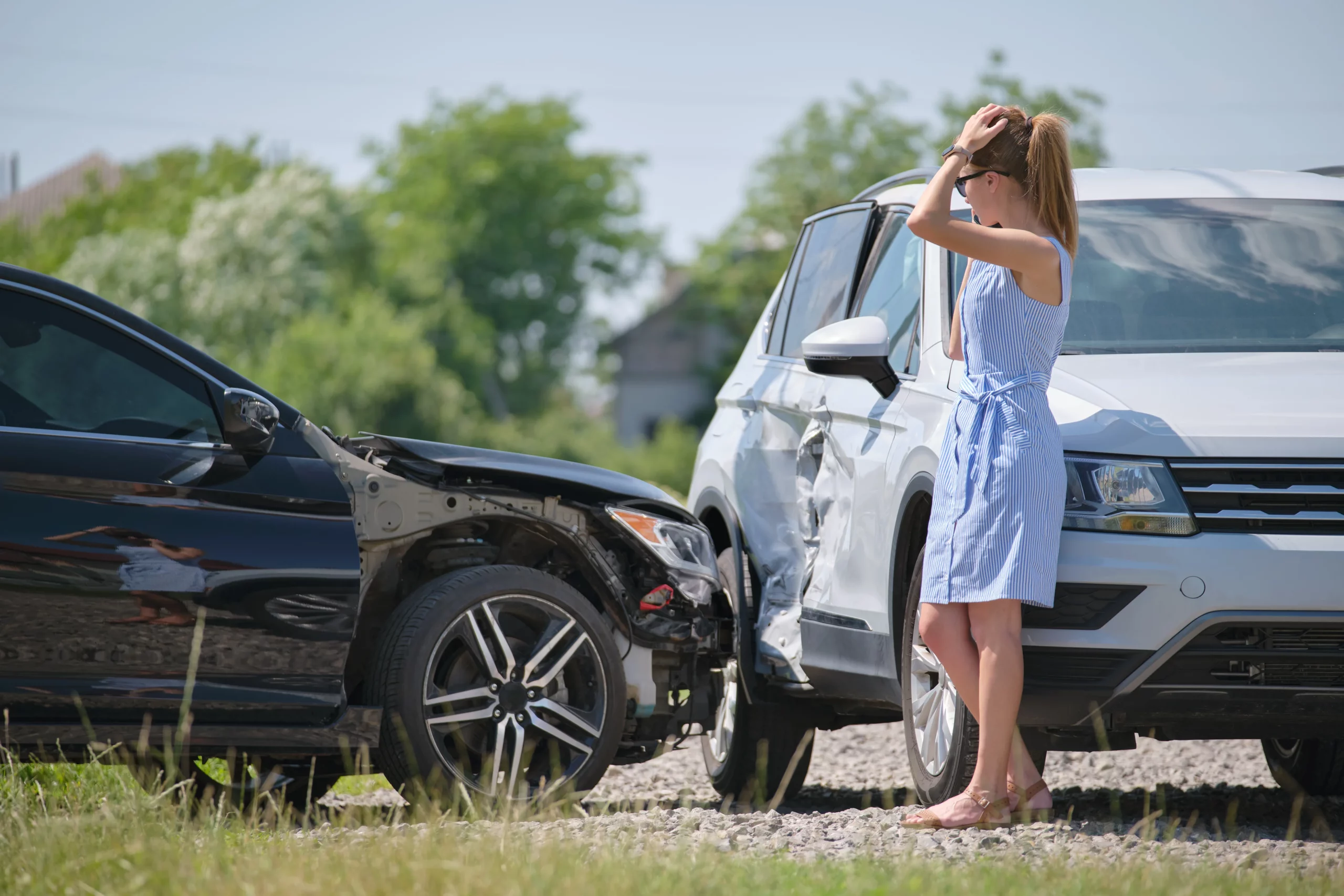 Woman standing near damaged vehicles after a Texas car accident involving partial fault